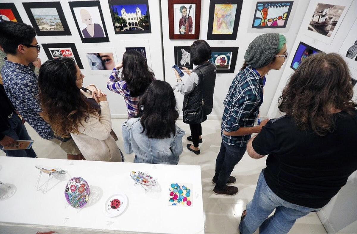 Patrons check out a previous exhibit at the Betsy Lueke Creative Arts Center. The center is holding a new exhibition called "Hidden Jewels” starting at 7 p.m. on Friday, Feb. 7 through Feb. 27.