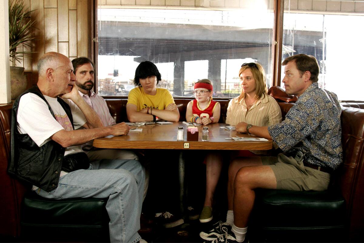 A family seated in a diner booth has a conversation
