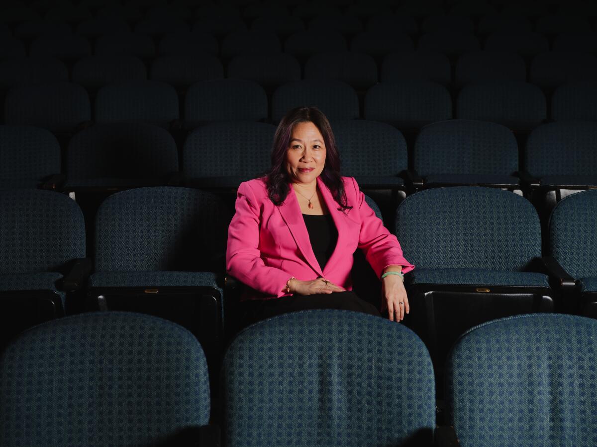 A woman seated in a theatre.