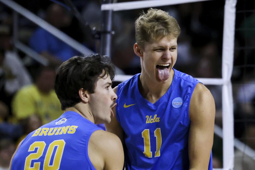 UCLA outside hitters Cooper Robinson (11) and Ethan Champlin (20) react during a match against Long Beach State in the NCAA college men's volleyball tournament, Thursday, May 4, 2023, in Fairfax, Va. (AP Photo/Julia Nikhinson)