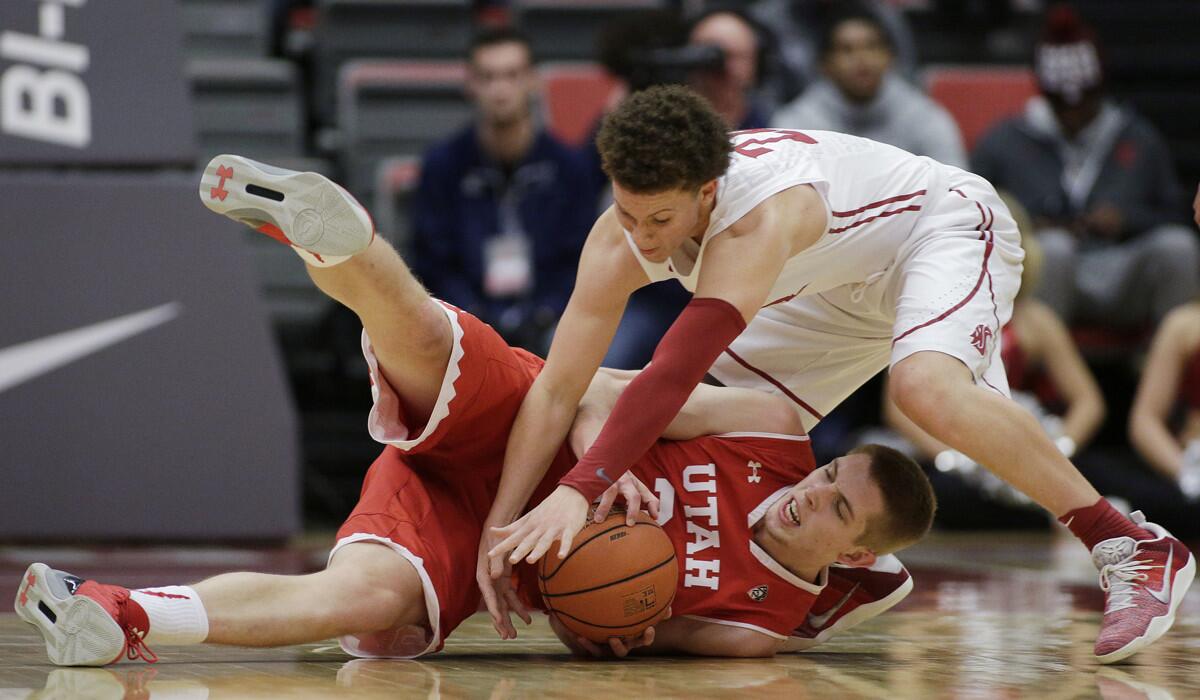Utah forward Tyler Rawson, left, and Washington State guard Malachi Flynn go after the ball during the second half on Wednesday.