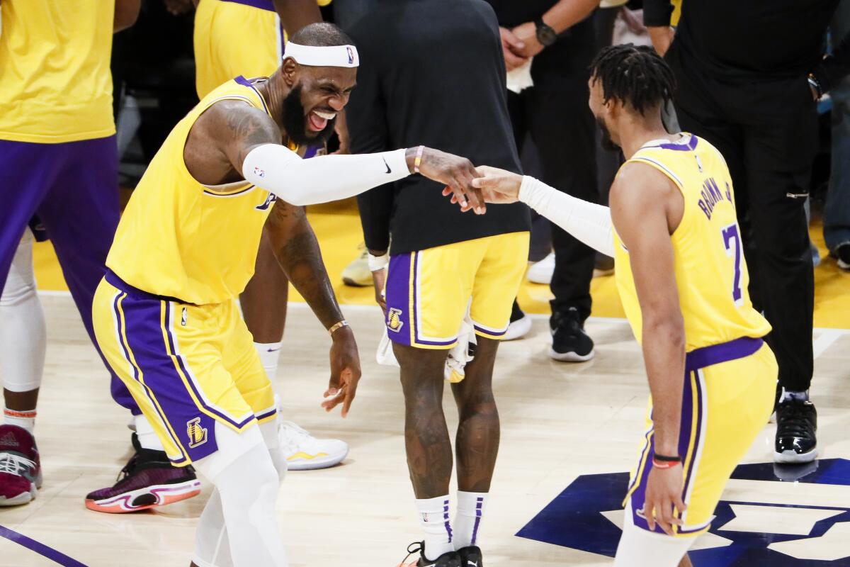 Lakers forward LeBron James celebrates with teammate Troy Brown Jr. after becoming the NBA's all-time scoring leader.