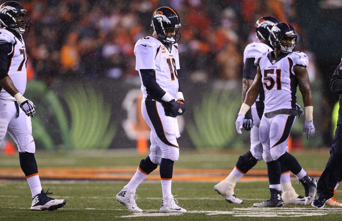 Denver quarterback Peyton Manning walks off the field after throwing an interception against the Cincinnati Bengals on Dec. 21.