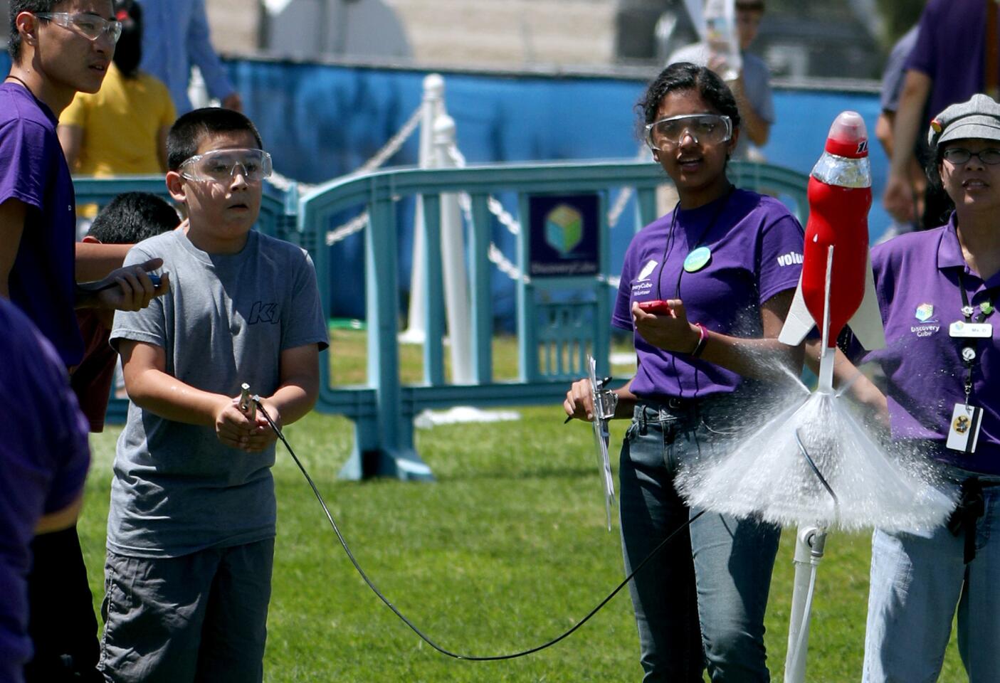 Alex Villasenor, 11 of Santa Ana, launches a water-propelled rocket made by his friend Adrian Padilla, 12 of Costa Mesa, at the annual Discovery Cube Rocket Launch event at the Boeing Company, in Huntington Beach on Saturday, May 11, 2019.