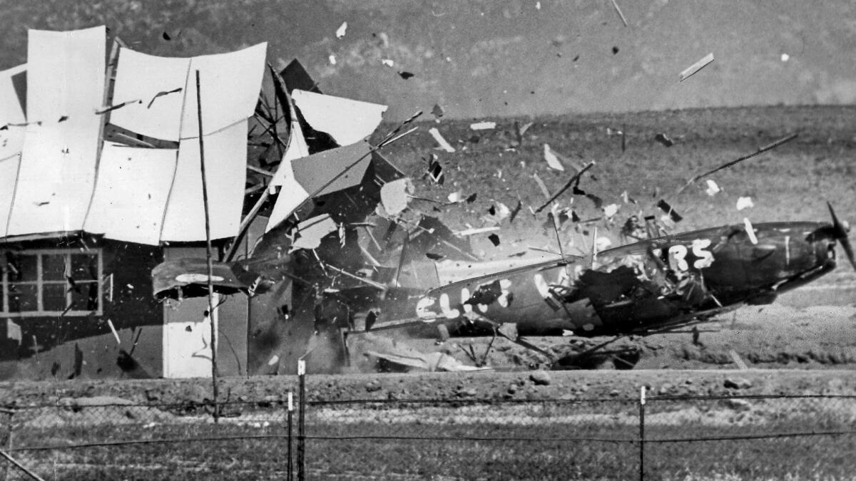 May 5, 1962: Stunt pilot Cliff Winters flies his plane through a building during the National Air Circus at Riverside Grand Prix Racetrack. Winters climbed out of the wreckage unhurt.