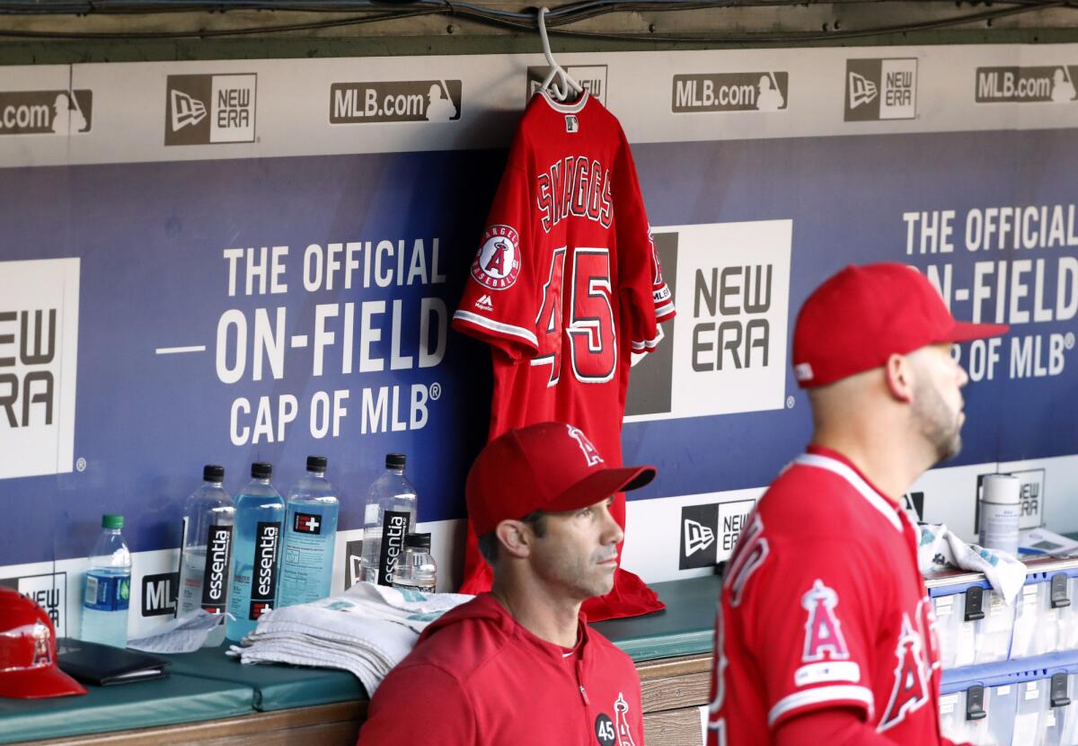 Angels manager Brad Ausmus sits on the bench in front of Tyler Skaggs' jersey during a July 2 game against the Texas Rangers.