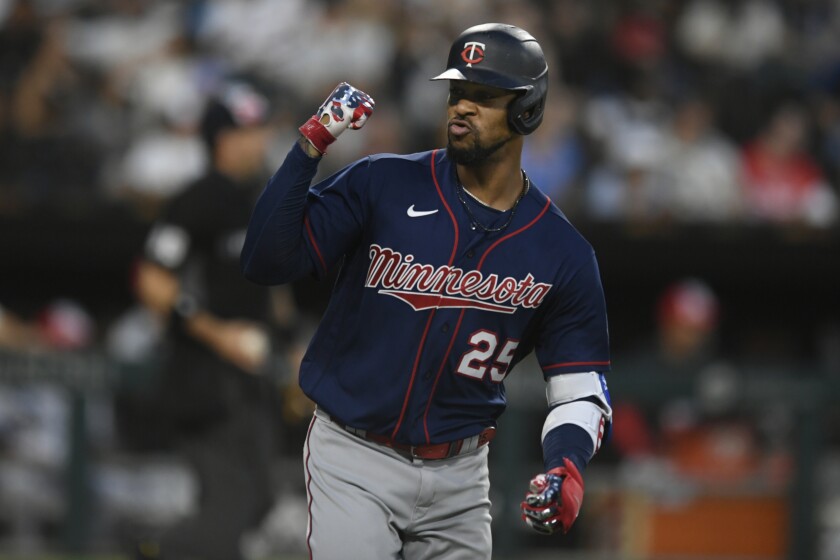Minnesota Twins' Byron Buxton celebrates while looking at teammates in the dugout after hitting a two-run home run during the fifth inning of a baseball game against the Chicago White Sox, Monday, July 4, 2022, in Chicago. (AP Photo/Paul Beaty)