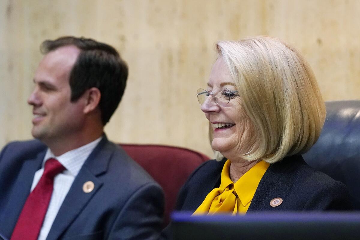 FILE - In this Sept. 24, 2021, file photo ,Arizona Senate President Karen Fann, R-Prescott, right, smiles as she is joined by state Sen. Warren Petersen, R-Gilbert, prior to the Arizona Senate Republican hearing on the review findings of the 2020 election results in Maricopa County at the Arizona Capitol in Phoenix. A judge has rejected the Republican-controlled Arizona Senate's contention that communications between Senate leaders and private contractors they hired to conduct a review of the 2020 election results in Maricopa County can be withheld on legislative privilege grounds. The ruling was released Thursday, Oct. 14, 2021. (AP Photo/Ross D. Franklin, File)