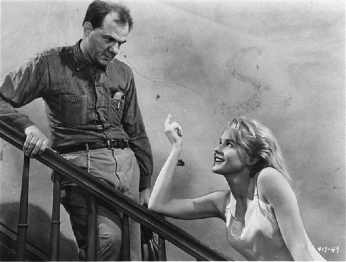 FILE - In this 1956 photo released by Warner Bros., actor Karl Malden, left, and Carroll Baker are shown in a scene from "Baby Doll." Malden, a former steelworker who won an Oscar for his role as Mitch in the 1951 classic "A Streetcar Named Desire," died Wednesday, July 1, 2009. He was 97. (AP Photo/Warner Bros. file)