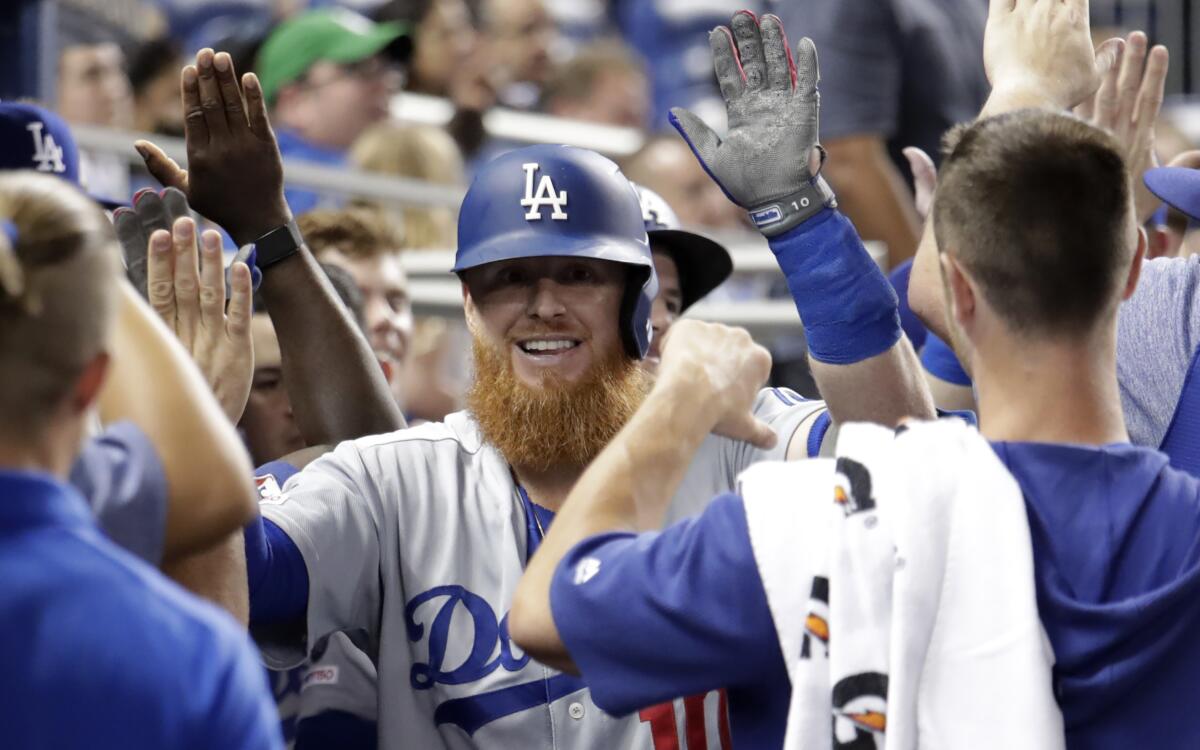 Justin Turner celebrates with his Dodgers teammates after hitting a two-run home run against the Miami Marlins on Tuesday.