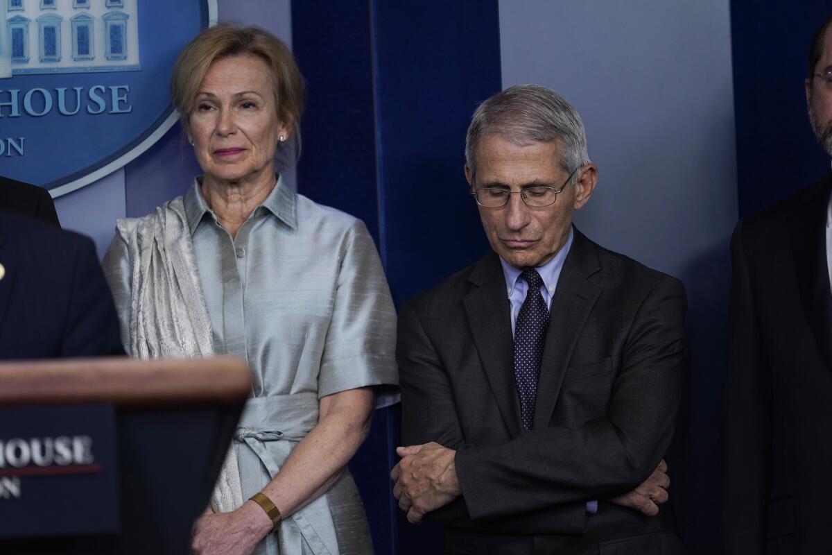 Dr. Deborah Birx and Dr. Anthony Fauci attend a coronavirus task force briefing at the White House in March. 