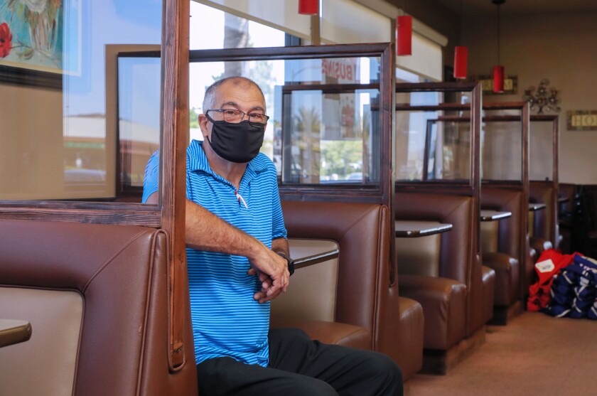 J&M Family Restaurant owner Joe Goncalves sits in a booth.