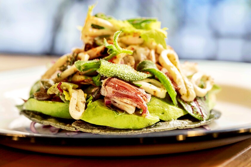 Grilled Squid Tostada, back, served at Bar Ama restaurant, in Downtown LA.