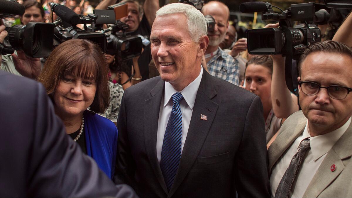 Indiana Gov. Mike Pence, center, and his wife, Karen, after meeting with Donald Trump in New York on Friday.