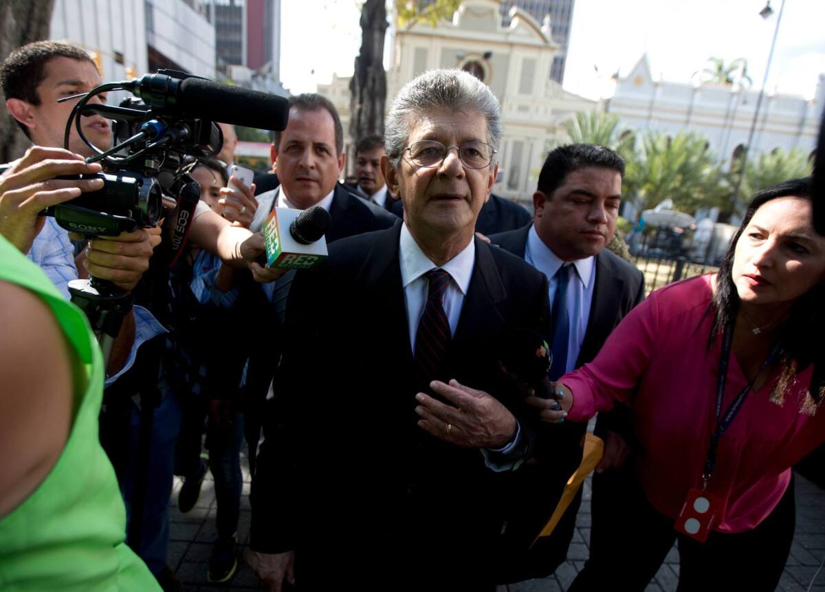 Henry Ramos Allup, incoming congress president, is surrounded by news media upon his arrival to the National Assembly building in Caracas, Venezuela.