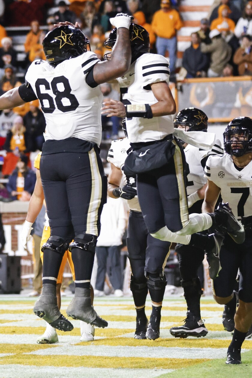 Vanderbilt quarterback Mike Wright (5) celebrates scoring a touchdown with offensive lineman Jason Brooks Jr. (68) during the second half of an NCAA college football game against Tennessee Saturday, Nov. 27, 2021, in Knoxville, Tenn. (AP Photo/Wade Payne)