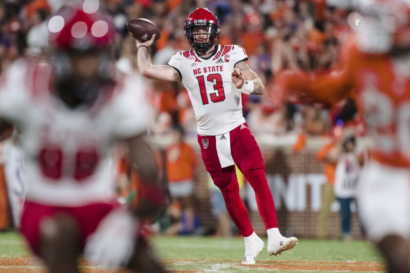 North Carolina State quarterback Devin Leary (13) passes the ball in the first half of an NCAA college football game against Clemson, Saturday, Oct. 1, 2022, in Clemson, S.C. (AP Photo/Jacob Kupferman)