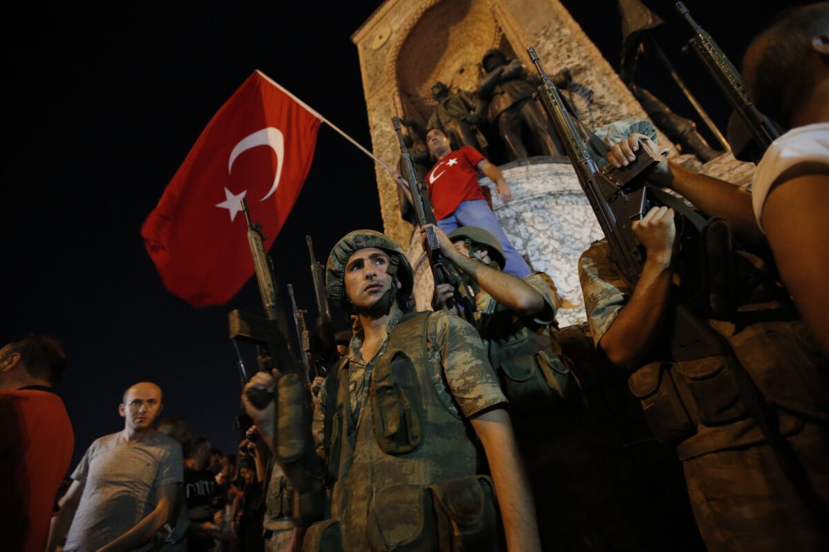 Turkish soldiers secure the area, as supporters of Turkey's President Recep Tayyip Erdogan protest in Istanbul's Taksim square.