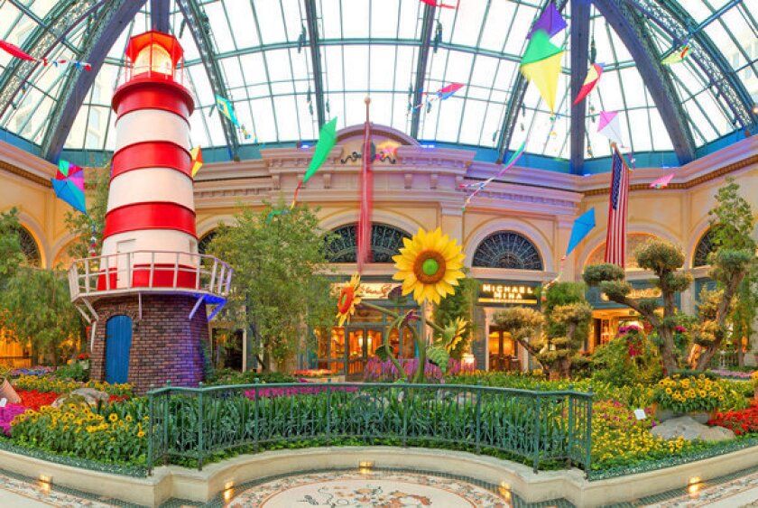 A red-and-white striped lighthouse beckons Vegas visitors to the colorful conservatory at Bellagio this summer.