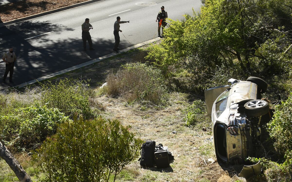 Tiger Woods' wrecked SUV lies on its side in the brush