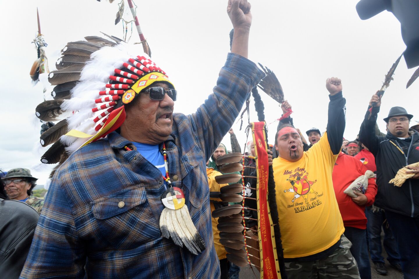 JR American Horse, left, raises his fist with others while leading a march to the Dakota Access Pipeline site in southern Morton County North Dakota on Friday.