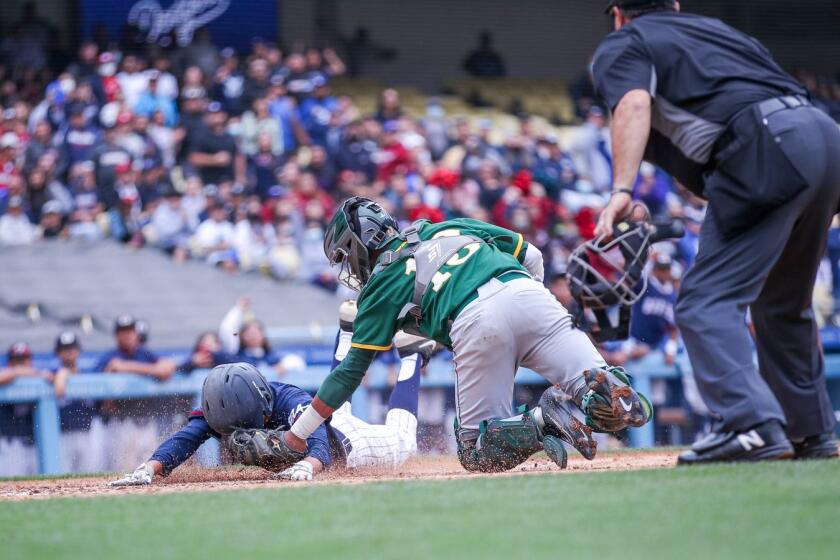 In a close play at the plate, catcher Jaylen Thomas of Narbonne tags Daniel Canales of Garfield .
