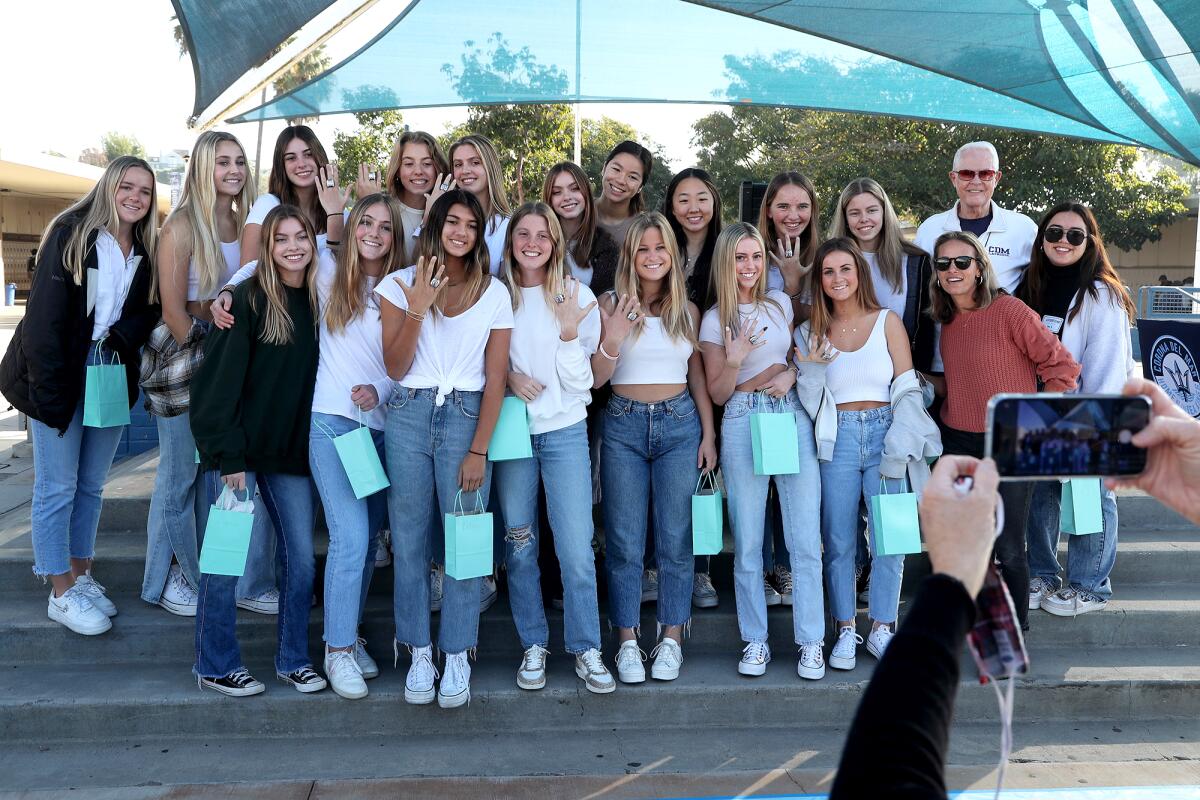 Members of the Corona del Mar High girls' lacrosse team pose for a group photo with their championship rings Wednesday.