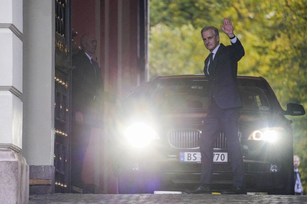 Norway’s prime minister-designate Jonas Gahr Store waves to the media as he leaves after an audience at the Royal Palace in Oslo, Thursday Oct. 14, 2021. Norway's Conservative Prime Minister Erna Solberg will step down as head of a three-party, minority center-right government after the left-leaning bloc won last month’s parliament election. (Ole Berg-Rusten/NTB via AP)