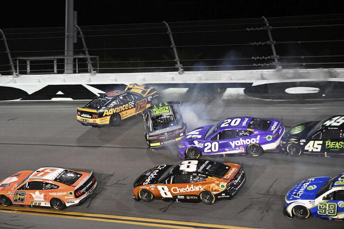 Ryan Blaney (12), Ty Gibbs (54) and Christopher Bell (20) collide during Saturday's NASCAR Cup race.