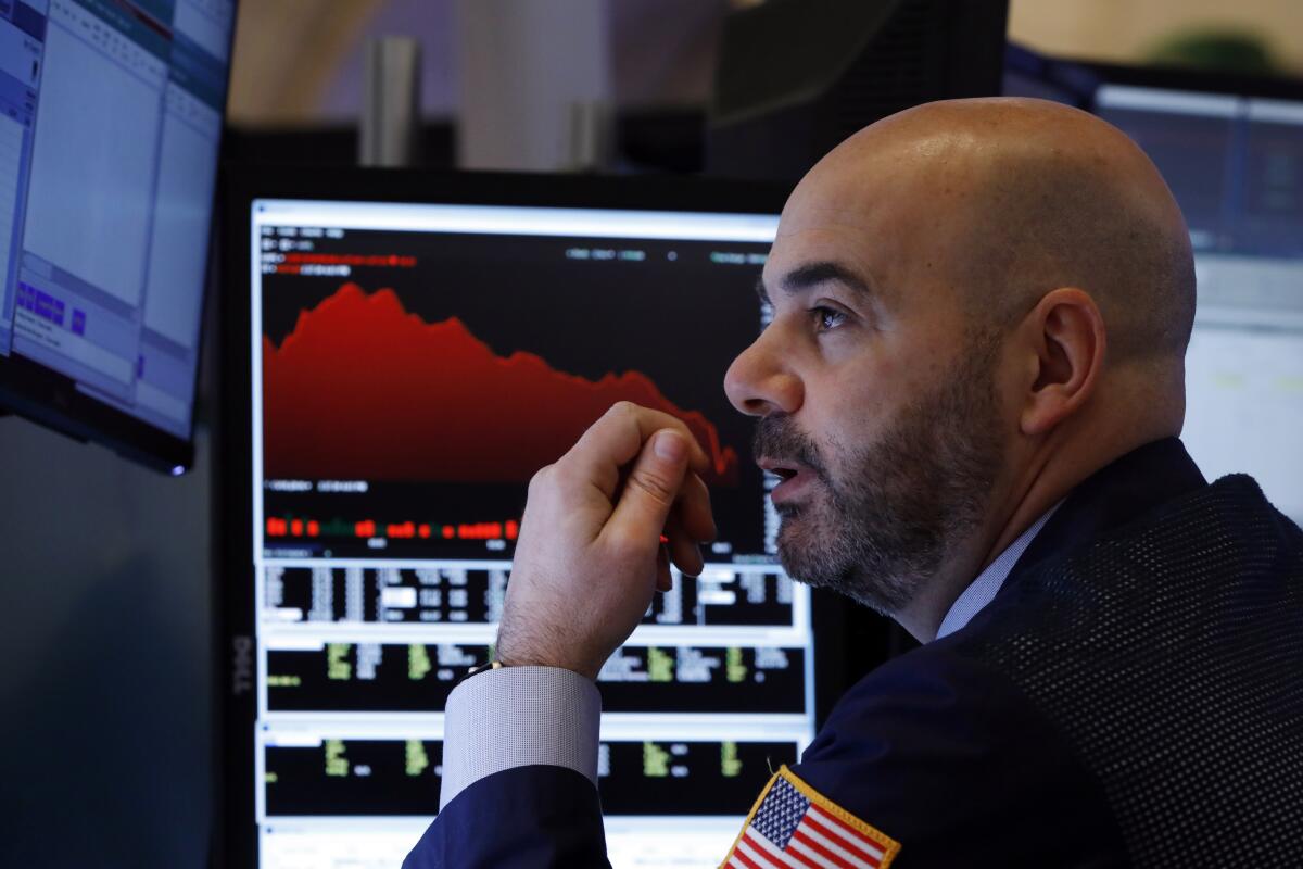 Trader Fred DeMarco works on the floor of the New York Stock Exchange. 