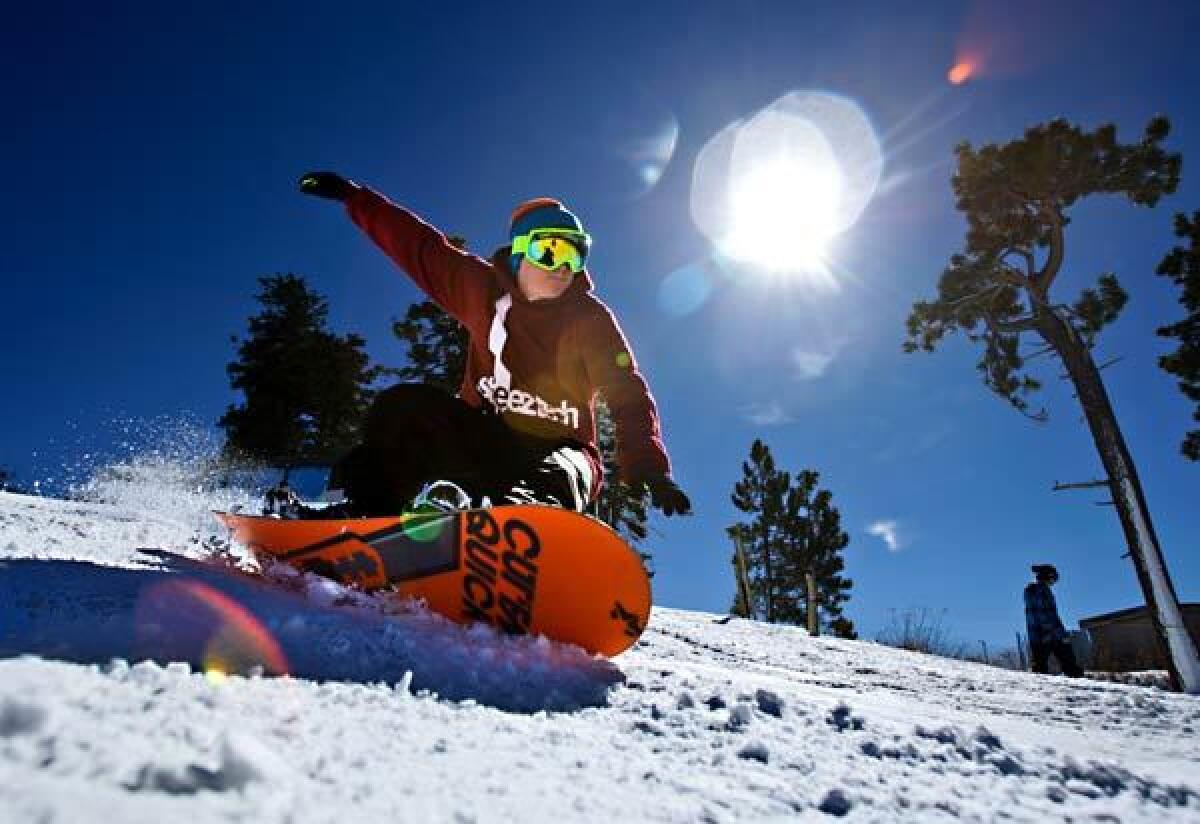 A snowboarder makes a sunlit run in November at Mountain High, near Wrightwood. The Southern California ski resort has a new 1.6-mile terrain park.