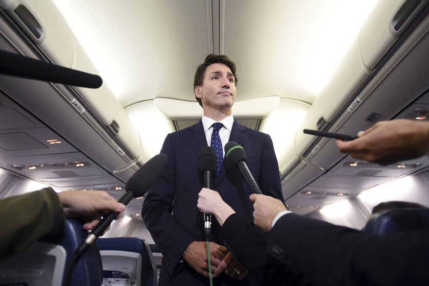 Canadian Prime Minister and Liberal Party leader Justin Trudeau makes a statement in regards to a photo coming to light of himself from 2001, wearing "brownface," during a scrum on his campaign plane in Halifax, Nova Scotia, Wednesday, Sept. 18, 2019. (Sean Kilpatrick/The Canadian Press via AP)