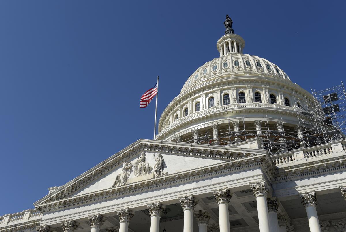 FILE - An American flag flies over Capitol Hill in Washington, Sept. 6, 2016. The United States dropped out of the top 25 for the first time to 27th place in the Transparency International’s 2021 Corruption Perceptions Index, which measures the perception of public sector corruption. The closely watched study finds that most countries have made little to no progress in bringing down corruption levels over the past decade. (AP Photo/Susan Walsh, File)