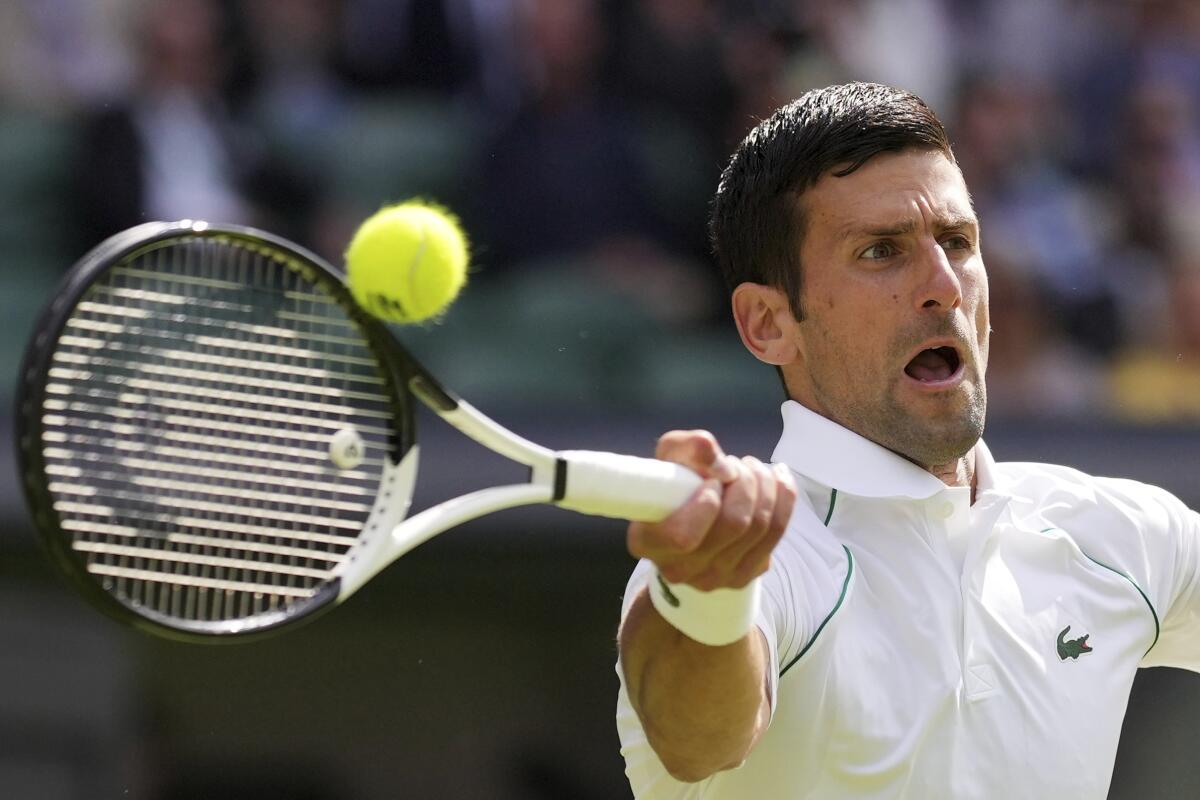 Novak Djokovic returns the ball to Miomir Kecmanovic during a Wimbledon third-round match July 1, 2022.