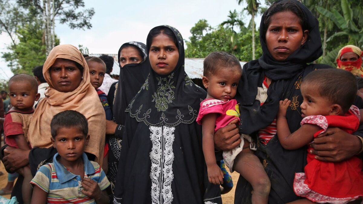Members of Myanmar's Muslim Rohingya ethnic minority wait to enter the Kutupalong makeshift refugee camp in Cox's Bazar, Bangladesh, on Aug. 28.