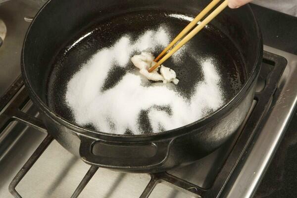 Melt beef fat in a hot sauté pan, covering the surface of the pan; then add sugar.