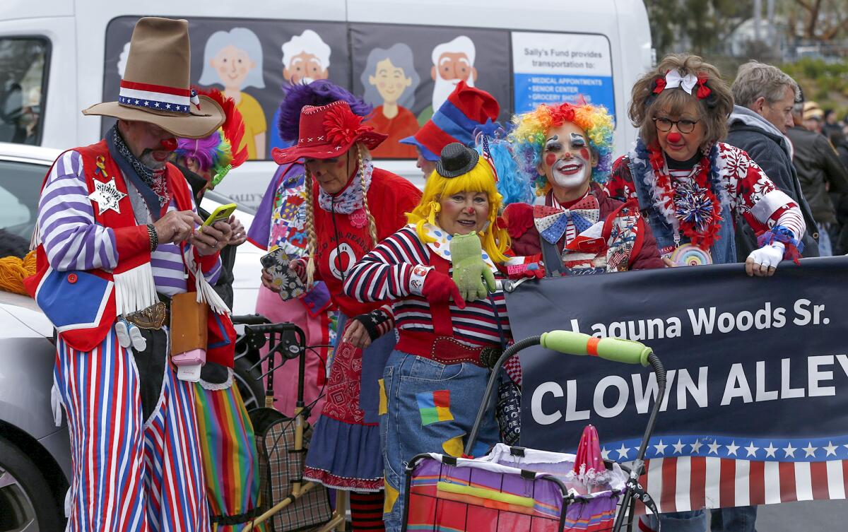 Members of the colorful Laguna Woods Clown Alley crew prepare for the 56th annual Patriots Day Parade in Laguna Beach.