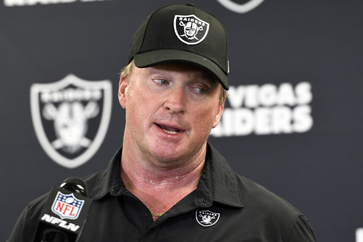 FILE - Las Vegas Raiders head coach Jon Gruden speaks with the media following an NFL football game against the Pittsburgh Steelers in Pittsburgh on Sept. 19, 2021. The former Raiders coach has sued commissioner Roger Goodell and the NFL, alleging that a “malicious and orchestrated campaign” was used to destroy his career by leaking old offensive emails from him. The suit was filed in district court in Clark County, Nev., on Thursday, Nov. 11, 2021, exactly a month after Gruden resigned as Raiders coach following the publication of his emails by the Wall Street Journal and New York Times. (AP Photo/Don Wright, File)