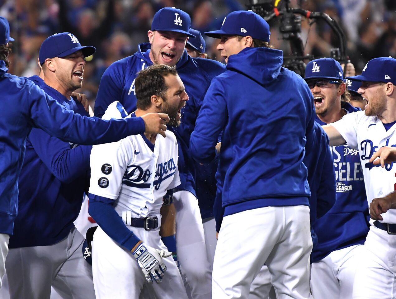 Dodgers left fielder Chris Taylor celebrates with teammates after hitting the game-winning two-run home run