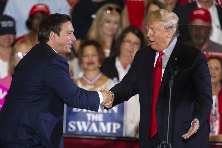 PENSACOLA, FL - NOVEMBER 03: U.S. President Donald Trump welcomes Florida gubernatorial candidate Ron DeSantis to the stage at a campaign rally at the Pensacola International Airport on November 3, 2018 in Pensacola, Florida. President Trump is campaigning in support of Republican candidates in the upcoming midterm elections. (Photo by Mark Wallheiser/Getty Images)