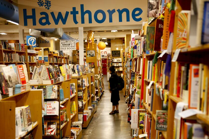 A customer browses at Powell's Books, whom the ILWU accused of putting out a 'misleading' statement about rehiring employees.