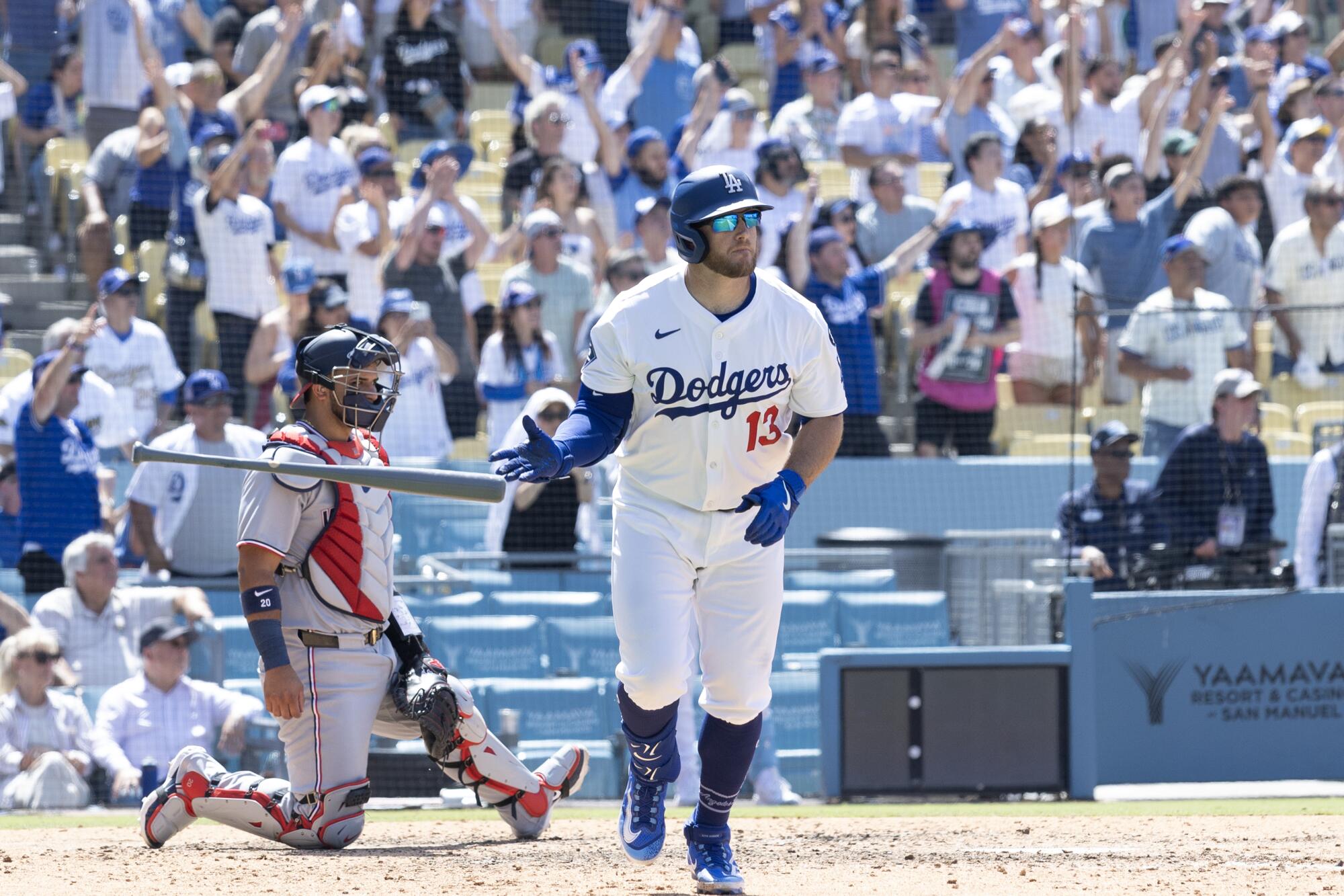 Max Muncy tosses his bat after hitting a three-run home run in the Dodgers' 13-7 win over the Washington Nationals.
