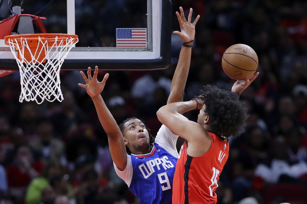 Los Angeles Clippers center Moses Brown defends against Houston Rockets guard Daishen Nix. 