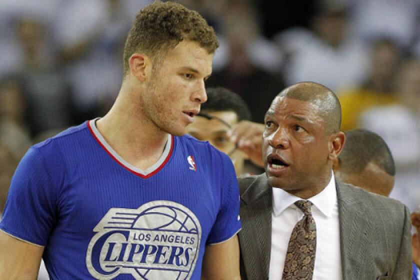 Clippers Coach Doc Rivers walks forward Blake Griffin off the court Wednesday after Griffin was ejected for his second technical foul against the Golden State Warriors.