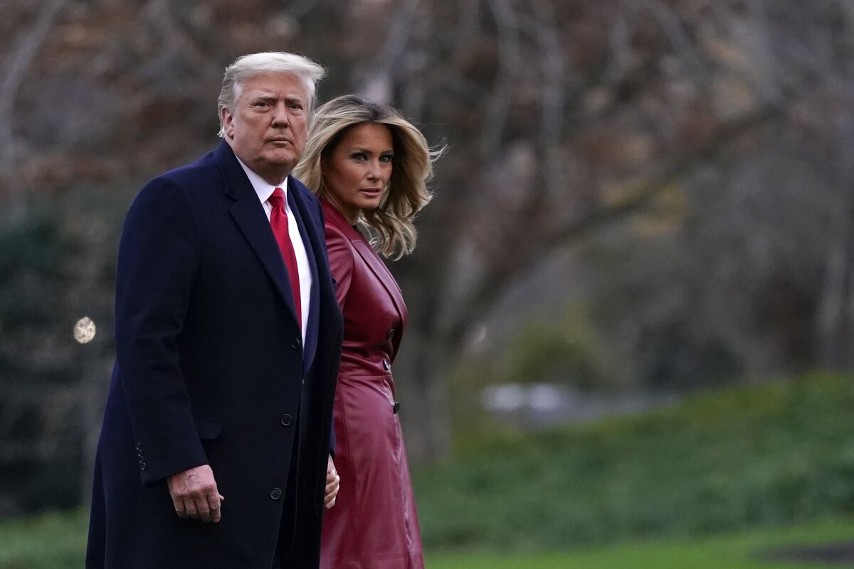 President Donald Trump and first lady Melania Trump walk on the South Lawn.