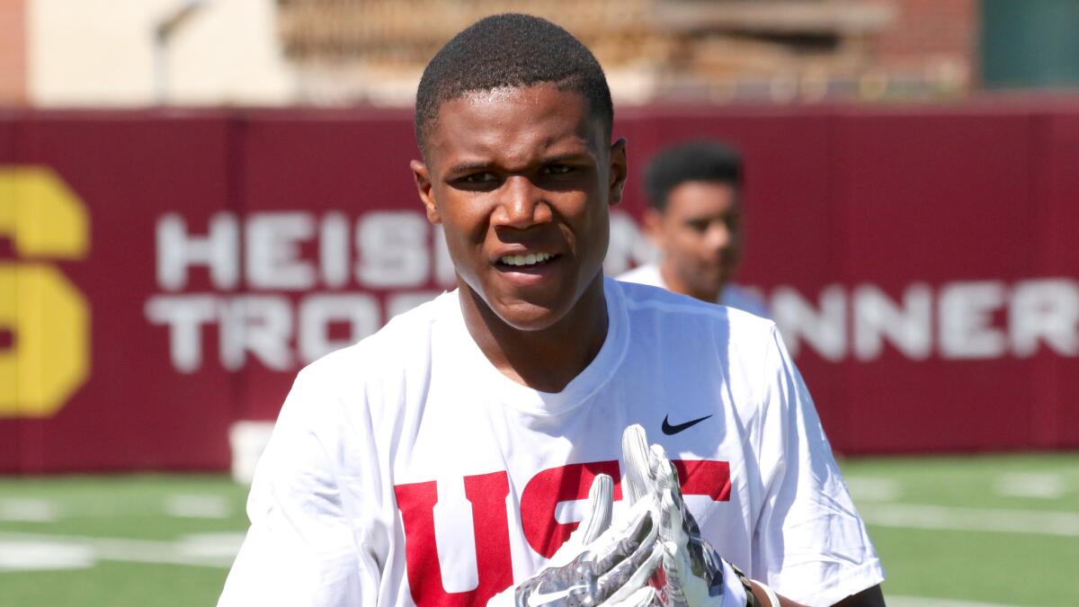 Cornerback Jeffrey Manning listens during a football camp at USC.