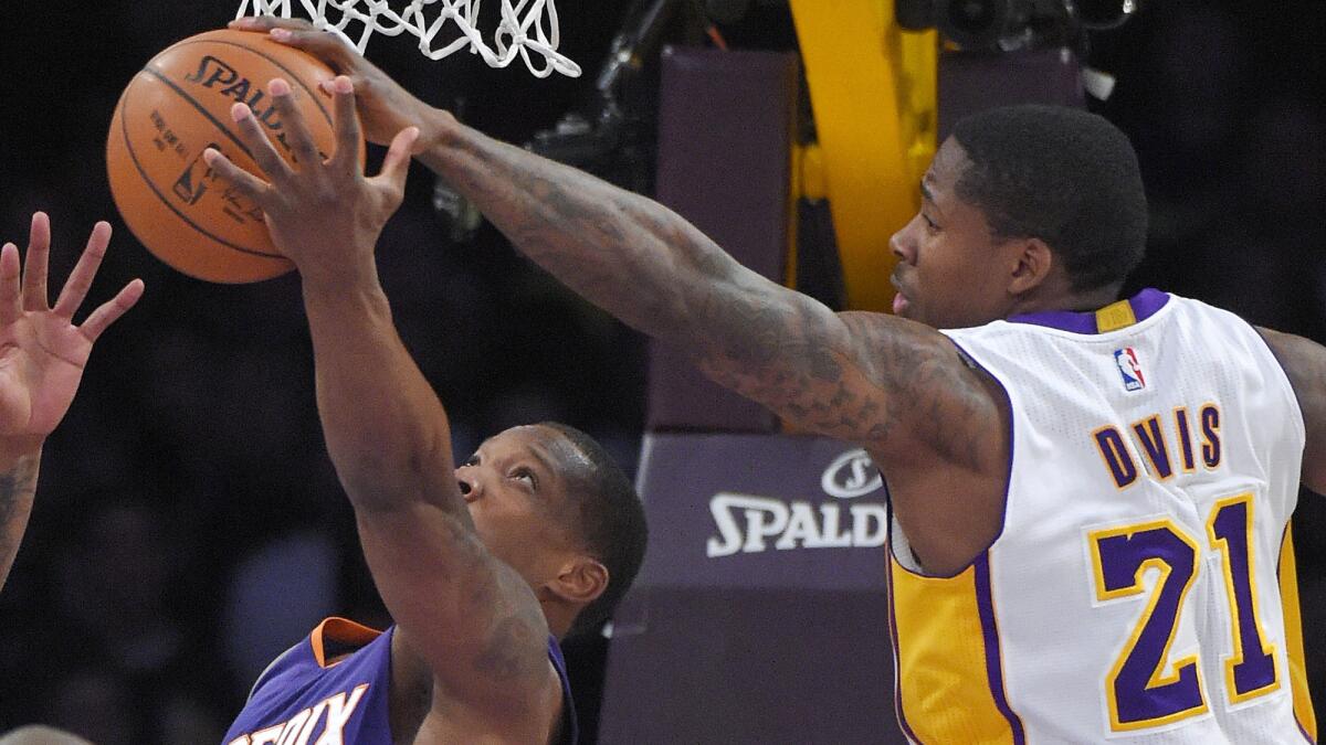 Lakers forward Ed Davis, right, blocks a shot by Phoenix Suns guard Eric Bledsoe during a game at Staples Center on Dec. 28, 2014.