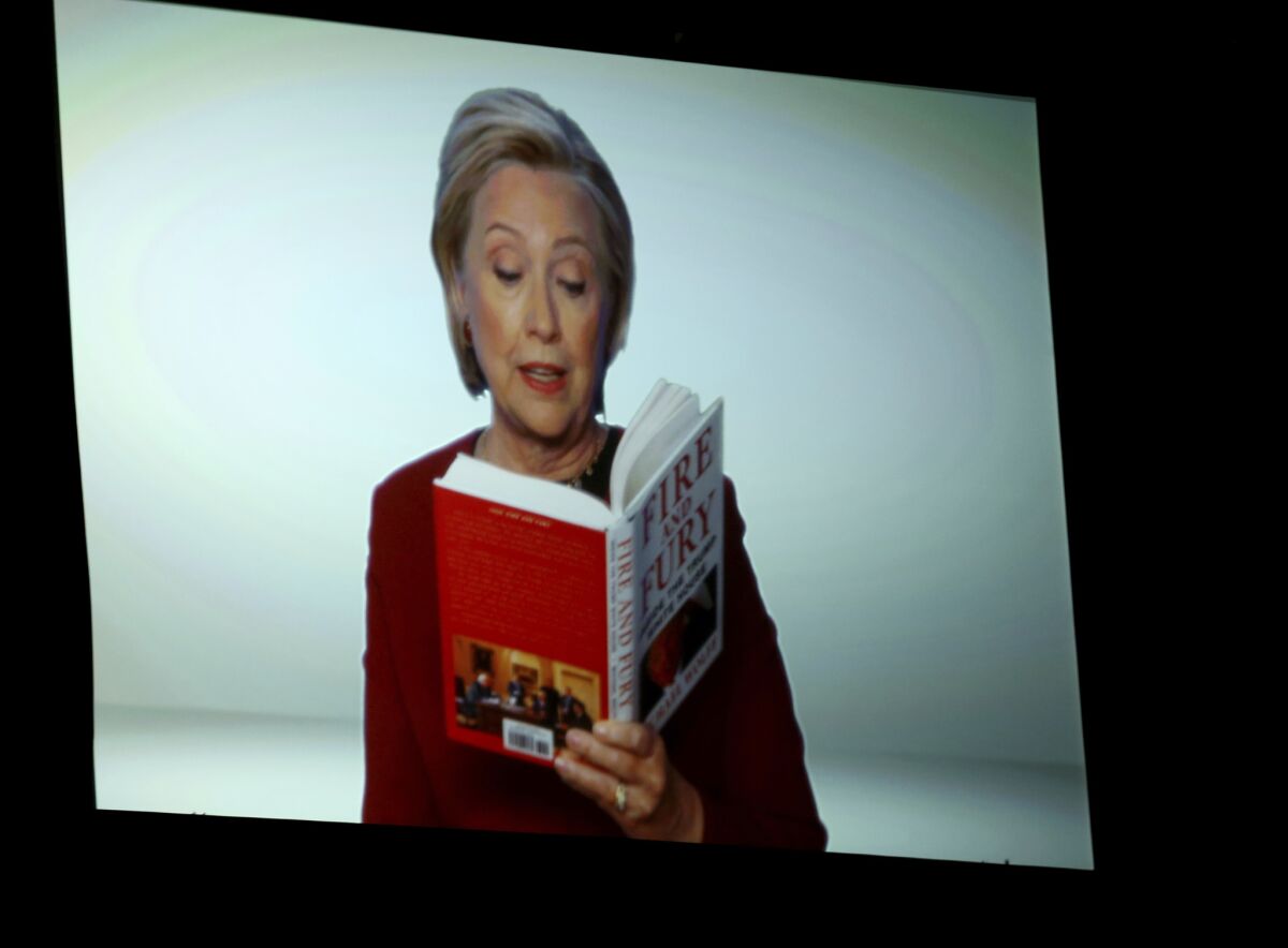 Hillary Clinton appears onscreen reading an excerpt from the book "Fire and Fury" during a skit at the Grammys.