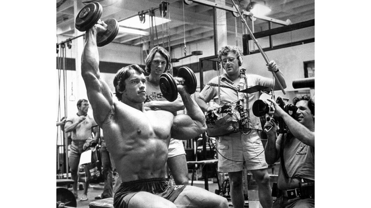 November 1975: A documentary film crew focuses on Arnold Schwarzenegger as he does a light workout at Gold's Gym in Venice before the International Federation of Bodybuilder's Mr. Olympia contest.