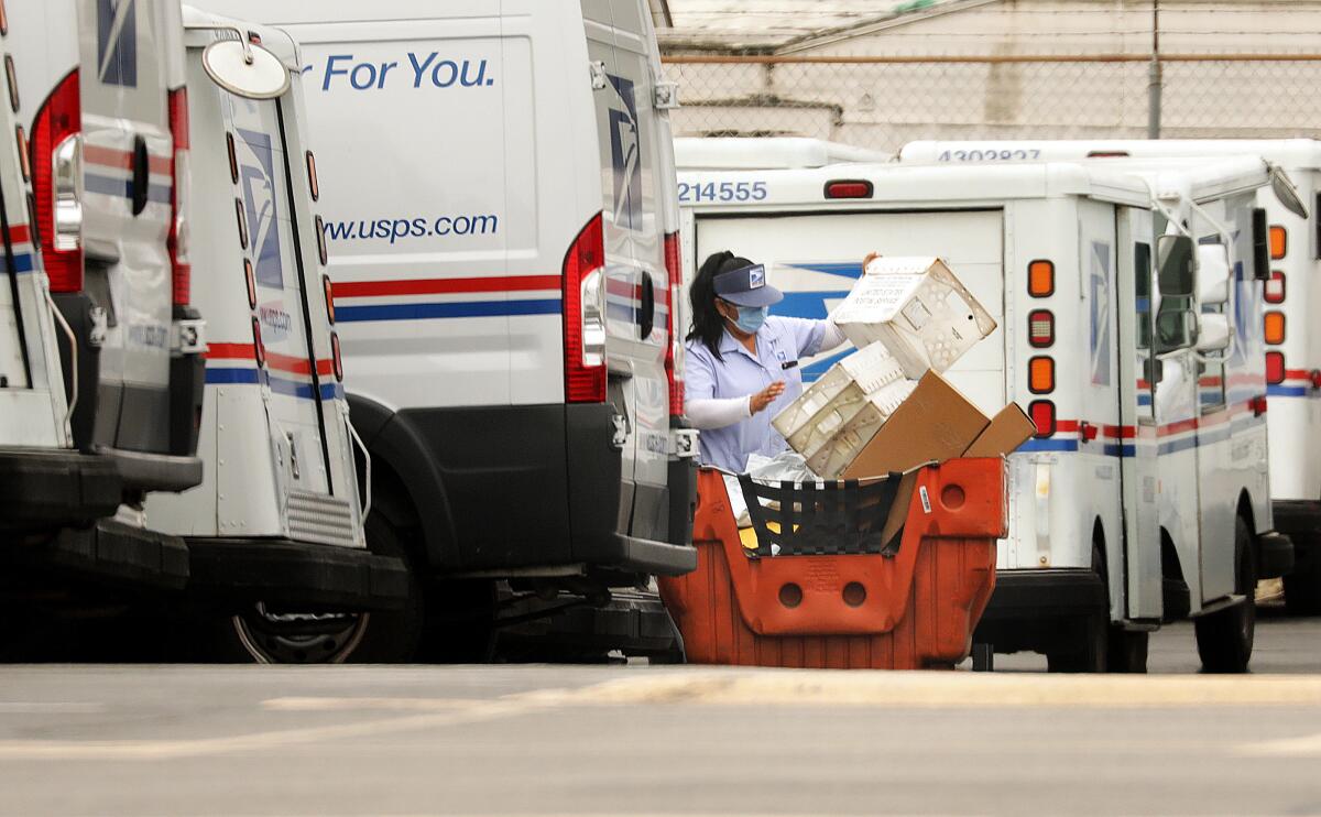 A mail carrier loads a truck for delivery at a post office in Torrance.